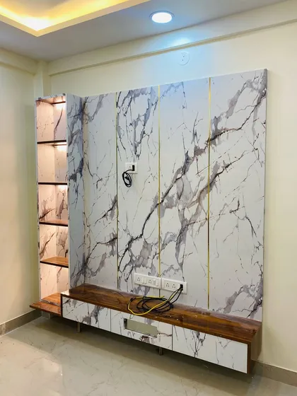 A variation of the marble TV unit, showing how different wood finishes can be paired with the same marble laminate for a customized look.