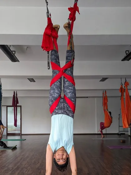 An inverted handstand supported by the aerial hammock, a common sight during our weekend classes.