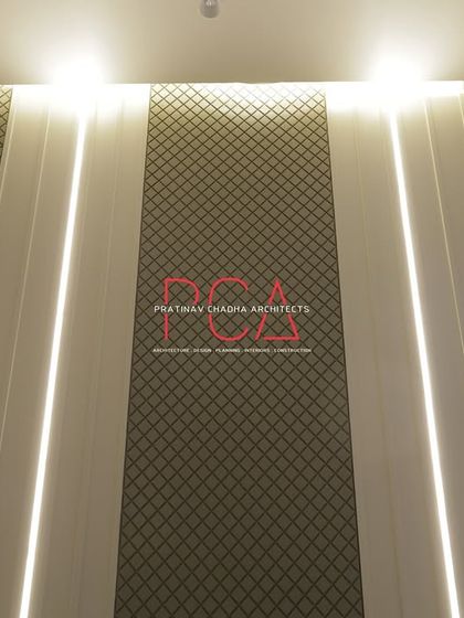 A close-up of the living room's feature wall, showing the combination of textured wallpaper and vertical lighting strips. This detail adds visual interest and a sense of height to the space.