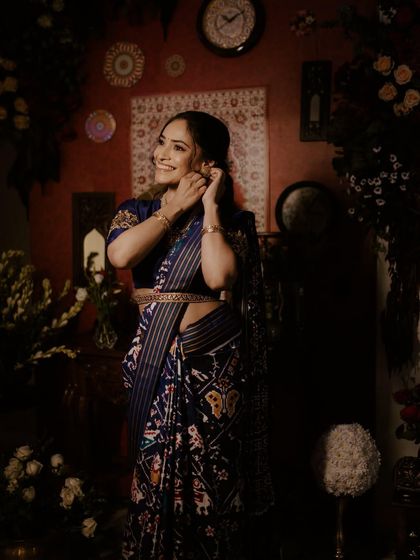 A stunning mother in a bold blue saree, her makeup kept soft and dewy to let her natural grace shine through.