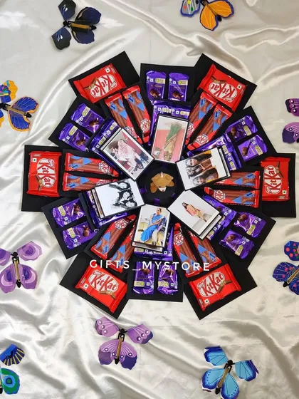 The full reveal! My butterfly chocolate explosion box opens up to release colorful butterflies, revealing chocolates and photos inside.