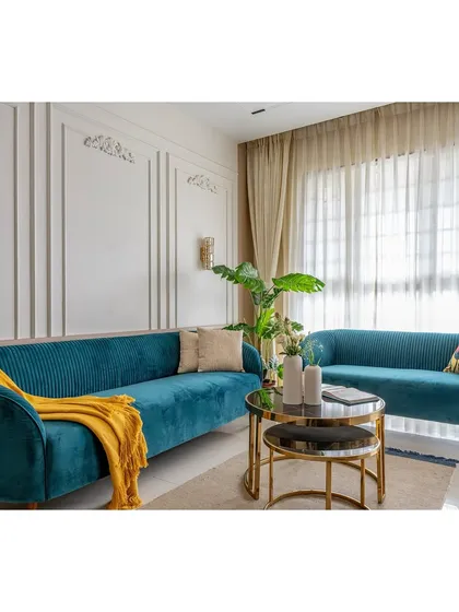 A bright, sunlit view of the teal living room. The yellow throw adds a complementary pop of color, demonstrating our approach to creating balanced and cheerful color palettes.