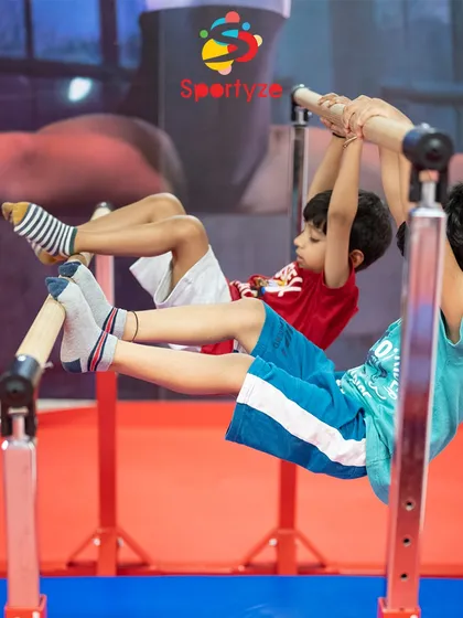 Our training starts with building a strong foundation. These young boys are developing crucial strength and control on the parallel bars, preparing them for more advanced moves.
