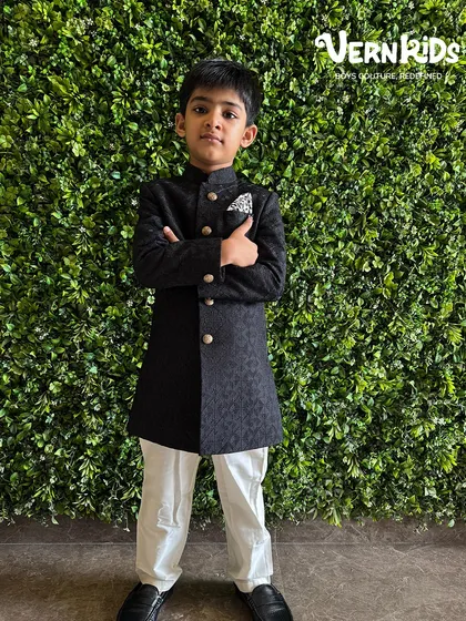 A classic black sherwani that exudes confidence. This timeless piece is a wardrobe essential for any young gentleman attending a formal event, offering a look that is both sharp and stylish.