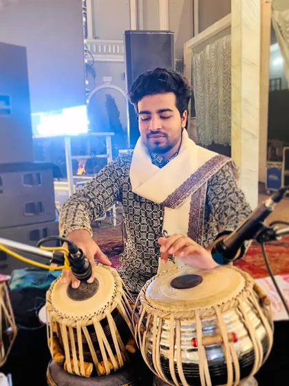 Focused on playing during the Sufi music performance.