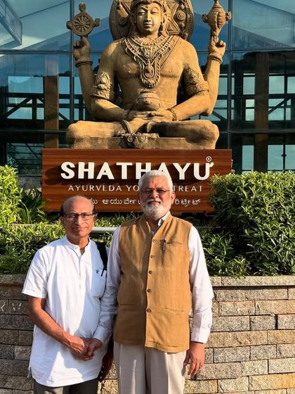 Dr. G.G. Gangadharan and our director in front of the Dhanvantari statue. This image symbolizes the passing of knowledge and our commitment to upholding the highest standards of Ayurveda.
