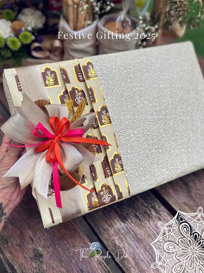 A glimpse into my festive gifting for 2025. This beautifully wrapped box uses a combination of textured paper and a patterned fabric band, finished with a multi-layered bow for a touch of modern Indian luxury.
