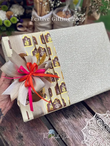 A glimpse into my festive gifting for 2025. This beautifully wrapped box uses a combination of textured paper and a patterned fabric band, finished with a multi-layered bow for a touch of modern Indian luxury.
