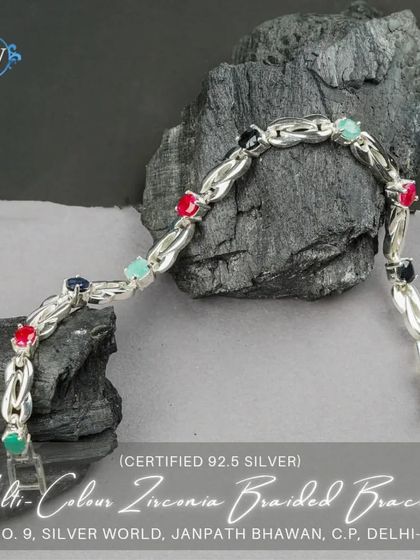 A multi-color braided bracelet featuring zirconia stones in various colors. This vibrant and playful piece adds a fun element to any outfit.