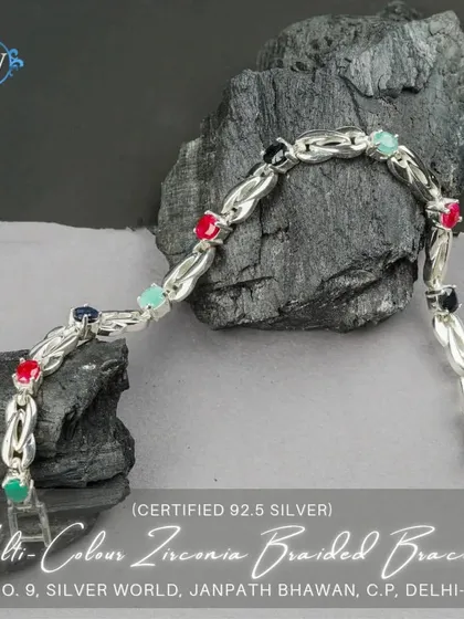 A multi-color braided bracelet featuring zirconia stones in various colors. This vibrant and playful piece adds a fun element to any outfit.