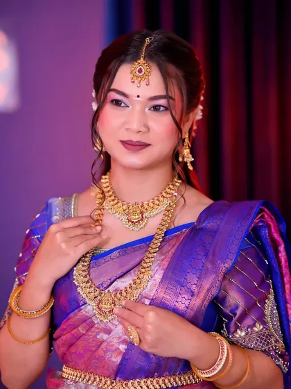 Another angle of the South Indian bridal look, showing the beautiful combination of purple and blue in the saree.