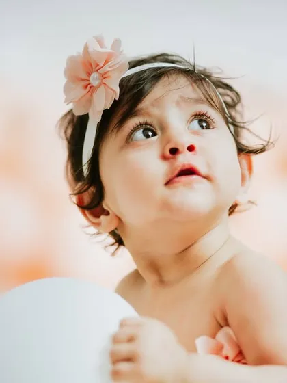 A beautiful, angelic portrait looking up. The soft lighting and clean background make this a truly timeless image.