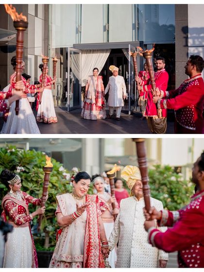 The couple's grand entrance at their 50th-anniversary vow renewal, led by performers with torches.