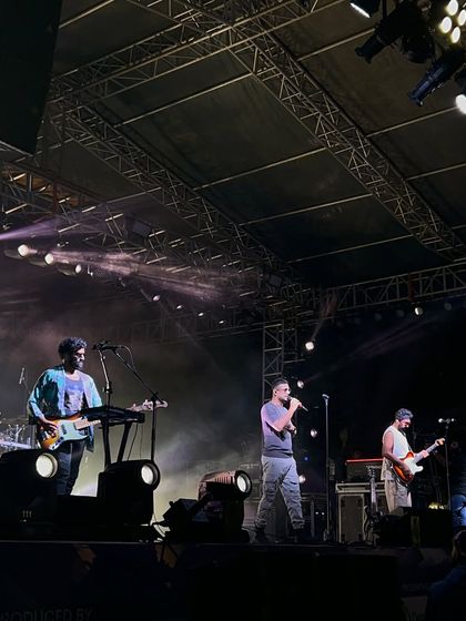 A clear shot of Sanam performing on our stage. The trussing and lighting rig above are visible, demonstrating the professional-grade setup we provide for every concert.