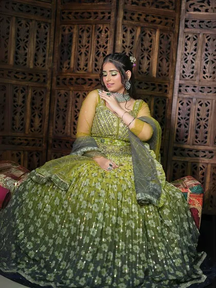 Feel like a princess in this beautiful peacock green floral lehenga. The sequin work catches the light perfectly, and the color is so unique. It's a great choice for a mehendi function or a festive celebration.