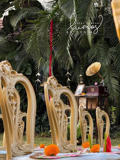 A close-up of the ornate gold chairs, highlighting the beautiful details and the traditional decor elements of the wedding.