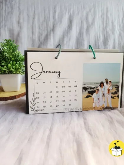 The January page of a ring-bound desk calendar, featuring a lovely family beach photo. A perfect start to the new year.