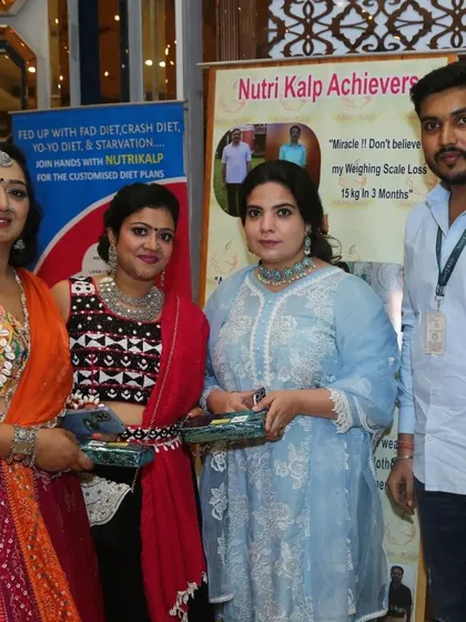 Our team with happy attendees at our stall during a festive exhibition. We love engaging with our community.