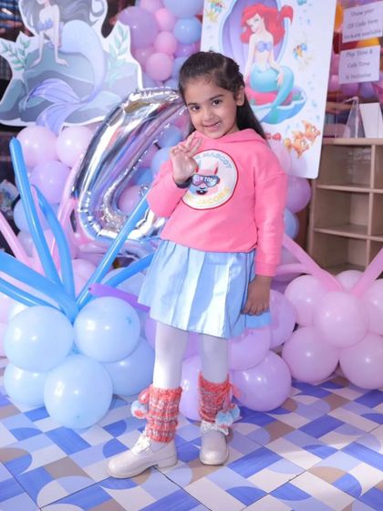 This little doll is wearing hand-knitted leg warmers I made for her birthday. They are a fun and practical accessory to keep little legs warm in style.