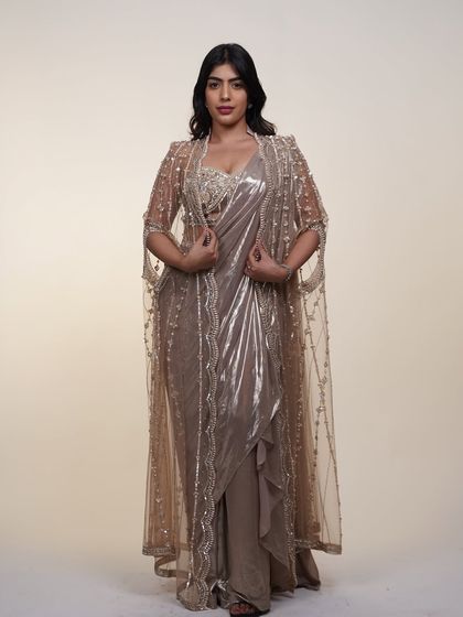 This metallic pre-draped saree with a sheer embellished cape is the definition of affordable luxury.