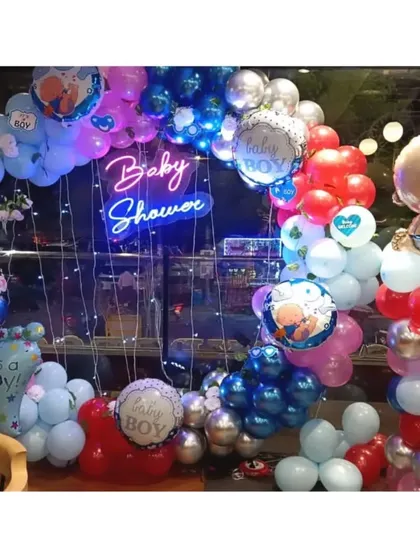 This baby shower setup for a boy was so much fun to create. I used a vibrant mix of red, blue, and silver balloons, a "Baby Shower" neon sign, and lots of cute baby-themed foil balloons to make it super festive.