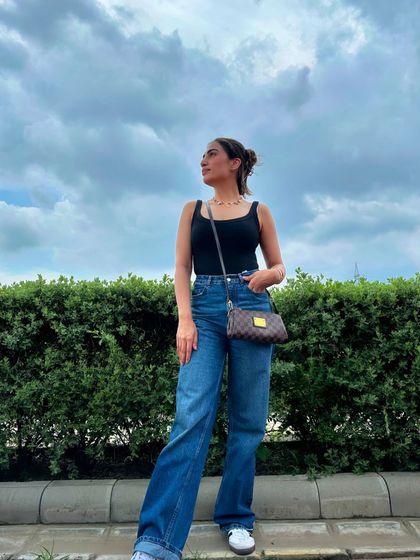 Another shot of the black tank and jeans combo, this time with my hair up in a bun for a more casual feel.