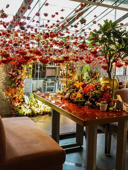 An overview of the Mehndi decor, where every corner was filled with color, from the floating flowers to the lush table arrangements.