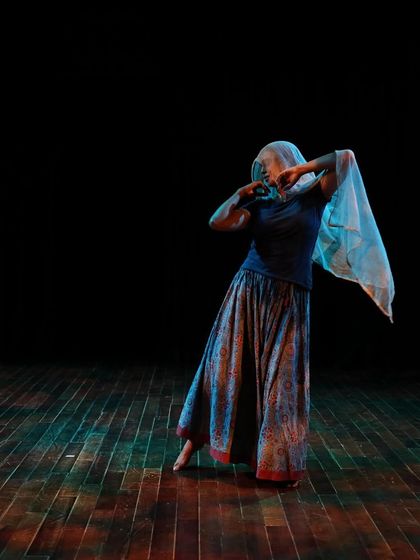 A dancer with a veil during a tech run.