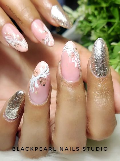 A glamorous combination of golden glitter and Russian swirl art. The intricate white swirls on a pink base are complemented by full-coverage glitter accent nails for a truly luxurious set.
