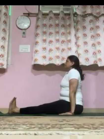 An instructor in Dandasana (Staff Pose), the foundational seated posture. We teach the importance of proper alignment in even the simplest of poses to build a strong practice.