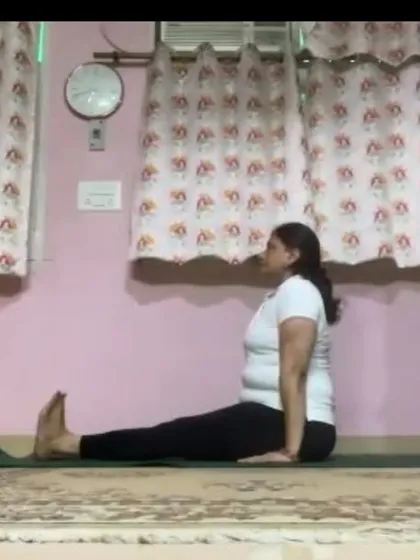 An instructor in Dandasana (Staff Pose), the foundational seated posture. We teach the importance of proper alignment in even the simplest of poses to build a strong practice.
