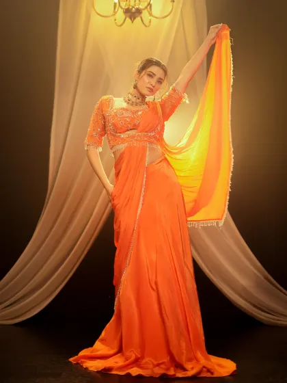 Another angle from the orange saree shoot, demonstrating how I capture multiple poses to provide a complete set for a designer's collection.