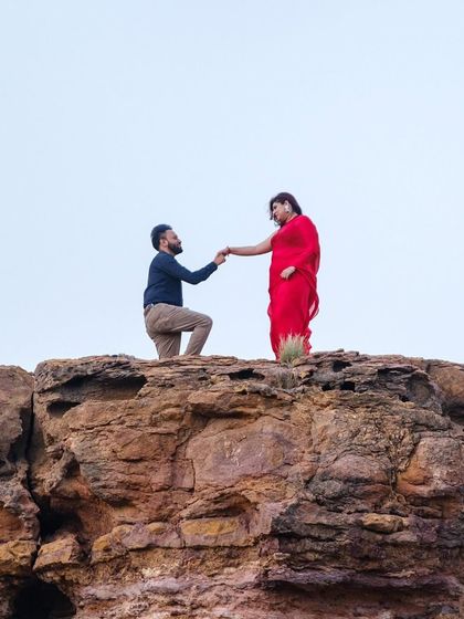 A dramatic proposal moment on a rocky outcrop in Jaisalmer. The stark landscape and his kneeling pose make for a powerful and romantic image.