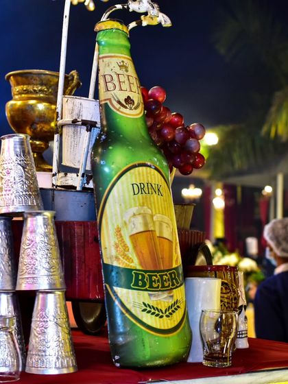 A quirky and fun beer station setup. I used a large decorative beer bottle and traditional Indian steel glasses to create a unique, desi-themed corner for beer enthusiasts.
