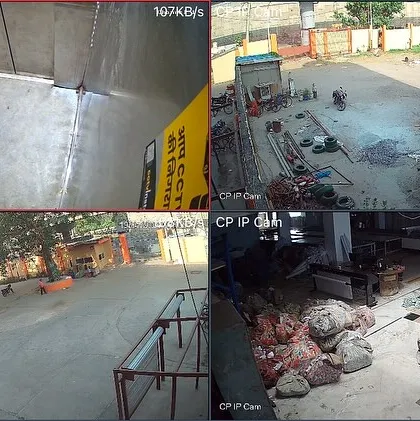 A four-camera IP feed from a large industrial site, showing a tanker truck, outdoor yard, and raw material storage. IP cameras provide superior clarity for large, open spaces.