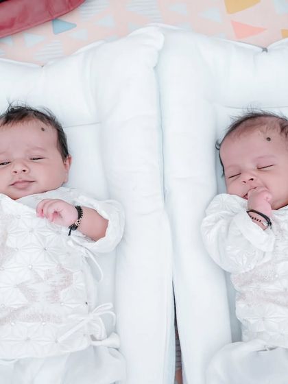 An adorable shot of the twin baby boys, Ved and Veer, resting together during their naming ceremony.