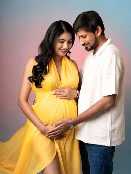 The way they look at each other is just everything! This couple's portrait captures a sweet, shared moment. Her vibrant yellow gown brings so much joy and brightness to the studio shot.