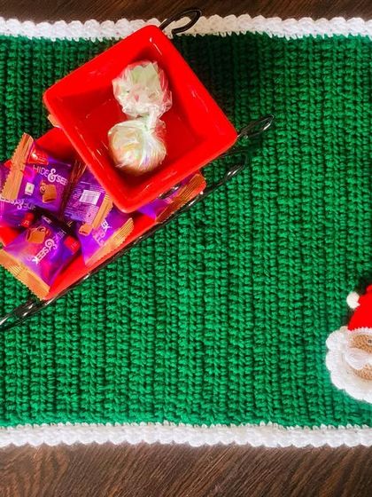 The green Santa placemat, shown from above. It's a great way to add a festive touch to your home.