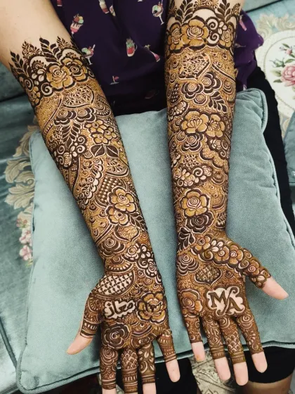 This bridal design was personalized with the groom's name, 'Maaz', and the couple's initials, 'MA', on the palms.