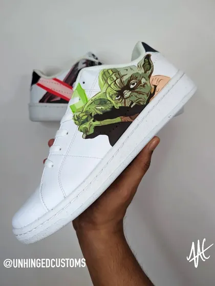 The Light Side. The other shoe in the pair features a detailed portrait of Master Yoda, ready for battle with his green lightsaber.