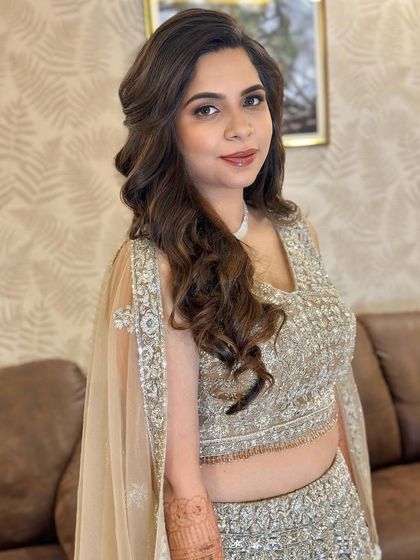 A portrait of the bride, looking poised and elegant. The makeup enhances her natural features beautifully.