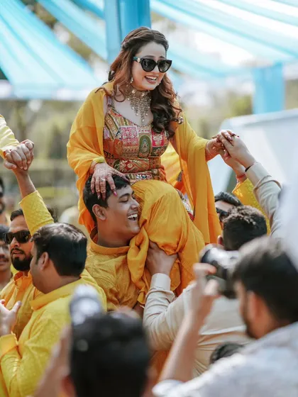 The bride makes a grand entrance at her Haldi ceremony, carried on the shoulders of her family. We capture these high-energy, unforgettable moments.