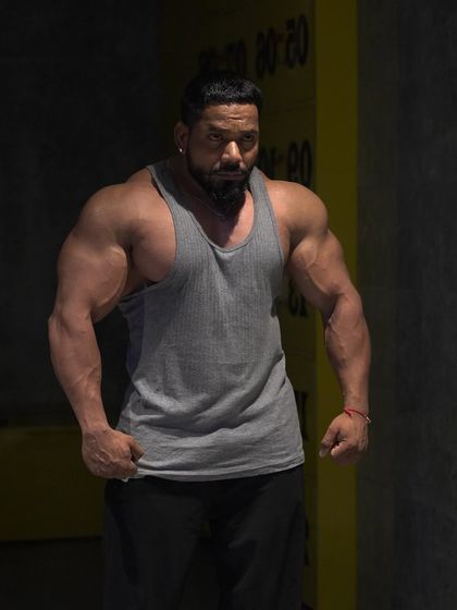 A relaxed but powerful stance. Even in a simple pose, the years of hard work are visible.