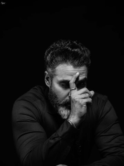 Another angle from our thoughtful series, this frame captures a pensive mood. The interplay of light and shadow across his face tells a story without a single word, a signature of my fine art portrait style.