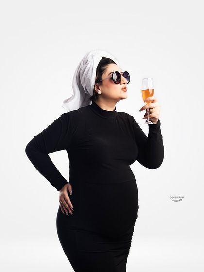 A fun and cheeky concept shoot! The client is styled with a towel on her head and sunglasses, sipping a non-alcoholic drink for a playful 'day off' vibe.