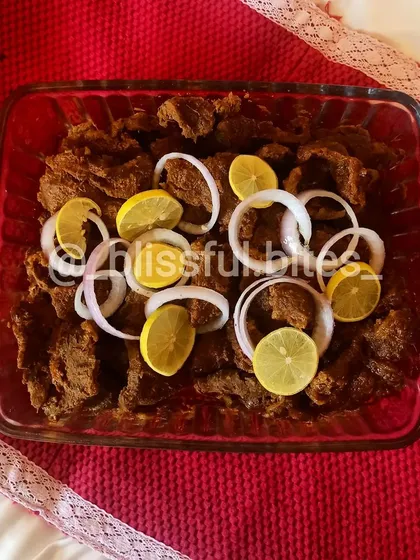 This is my Steak Phaal, an intensely flavorful and spicy Indian-style steak dish. The meat is marinated and cooked in a thick masala until tender, then served with fresh onion rings and lemon wedges to balance the heat.