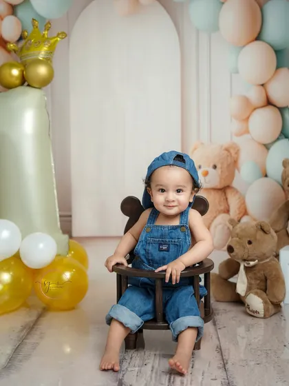 A happy smile from the birthday boy in his denim overalls. I love capturing these bright, expressive moments that show off a one-year-old's personality.