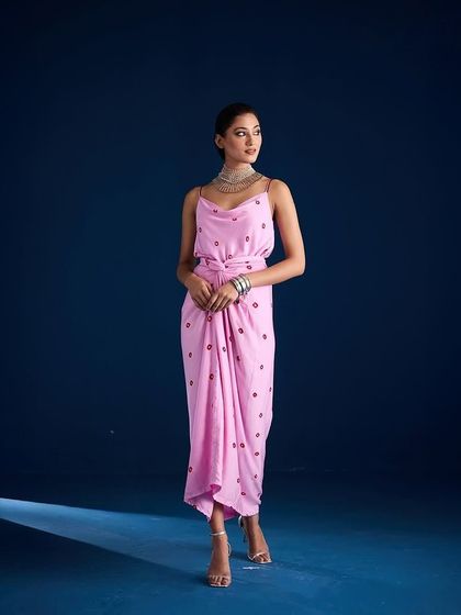 A shot of the Adila Wrap Dress by Aapro, capturing its elegant silhouette with dramatic lighting.