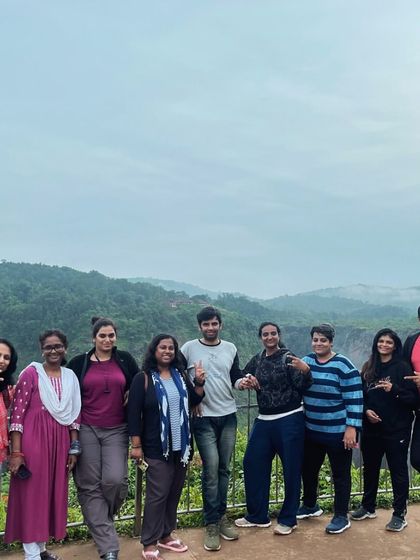 The group posing at a viewpoint overlooking Jog Falls.