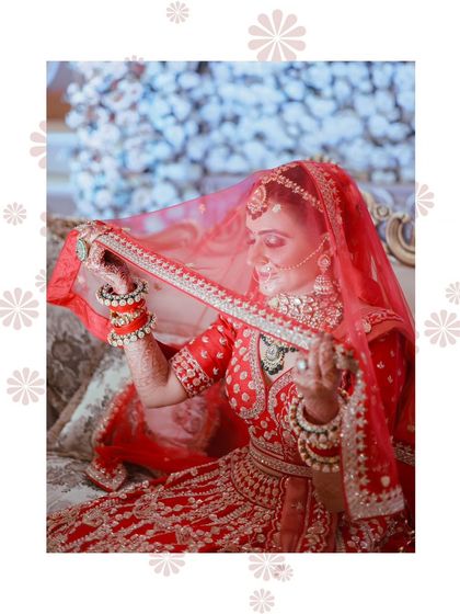 A classic bridal pose, looking down with the veil creating a soft frame. This is a timeless and elegant shot.